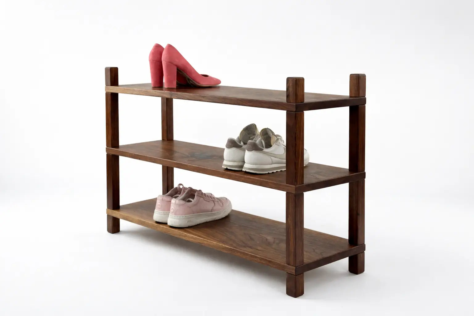 Wooden shoe rack with shoes on a white background