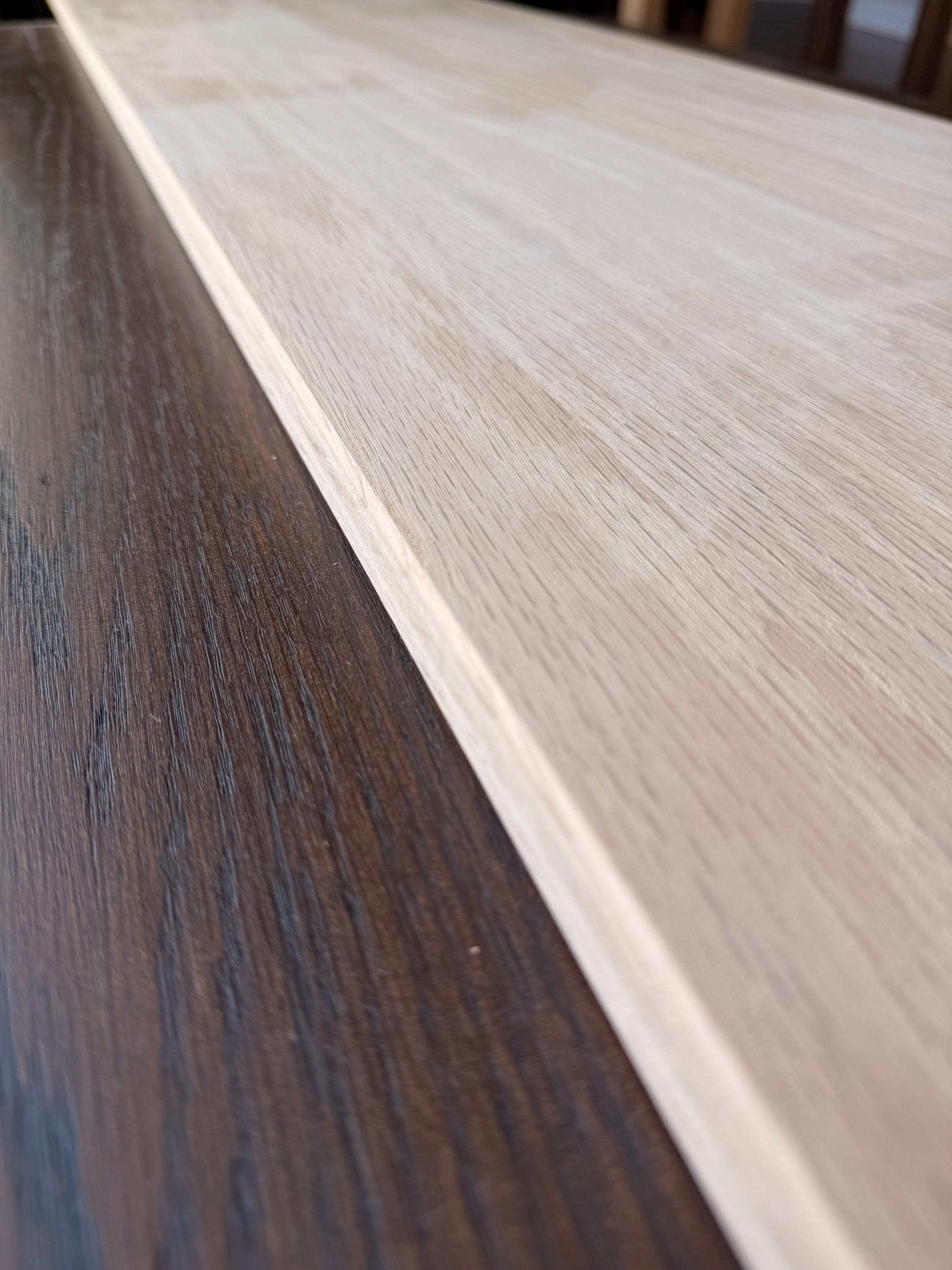 Close-up along the edge of the oak board showing its 3/4 inch thickness and clean sanded edge