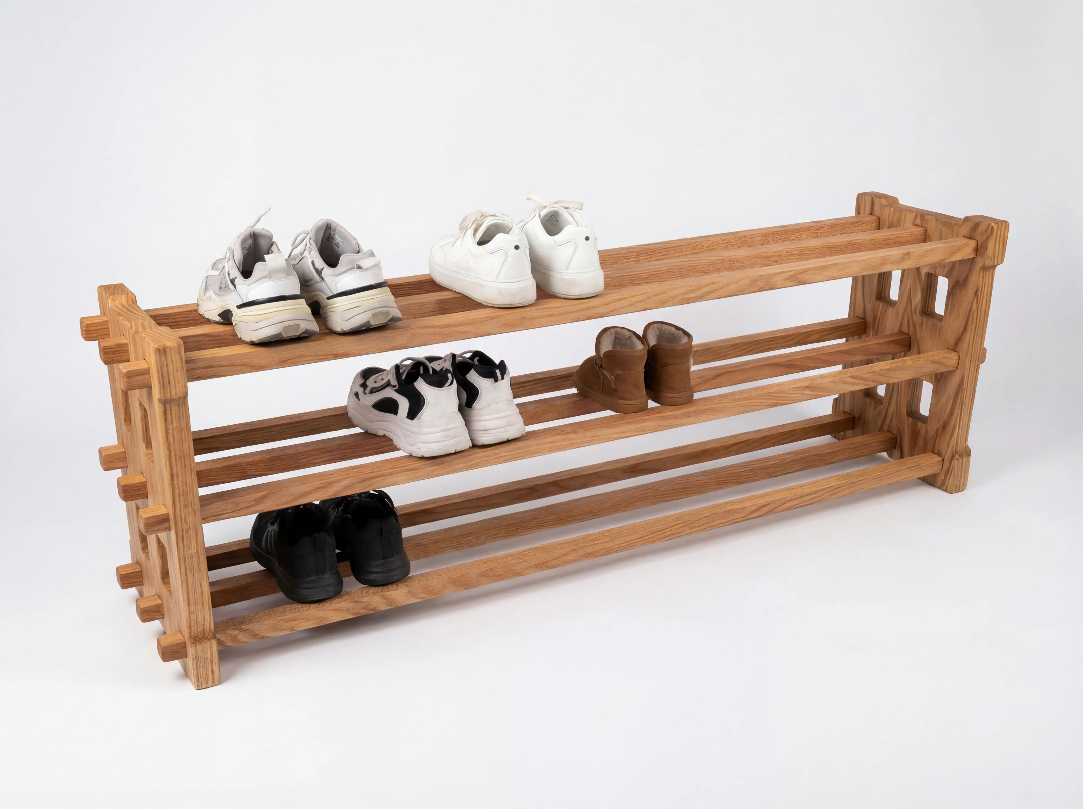 Wooden shoe rack with shoes on a white background
