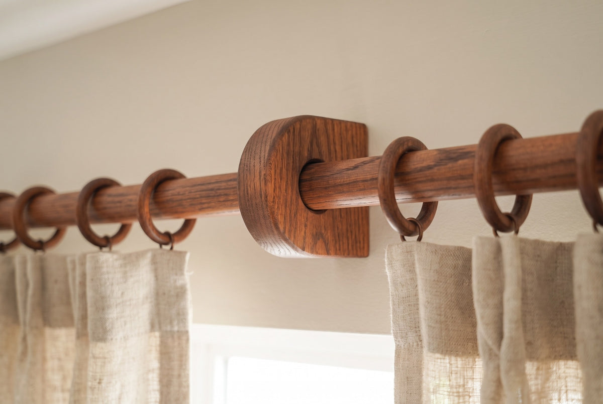 Center bracket of an ultra long oak curtain rod, with curtain rings stopping on both sides