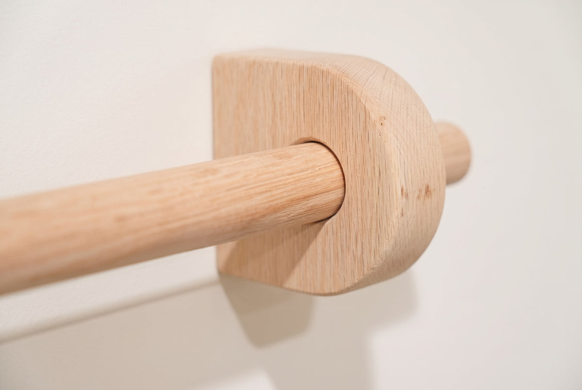 Unfinished | Unfinished sanded oak curtain rod through a round solid oak bracket